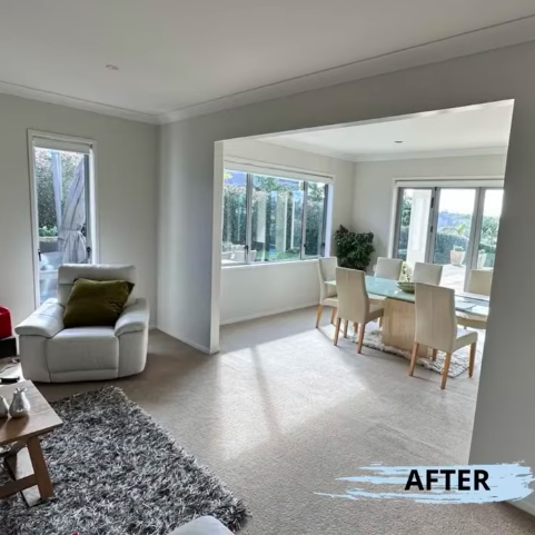 photo of an open plan lounge and dining area with cream carpets and white walls