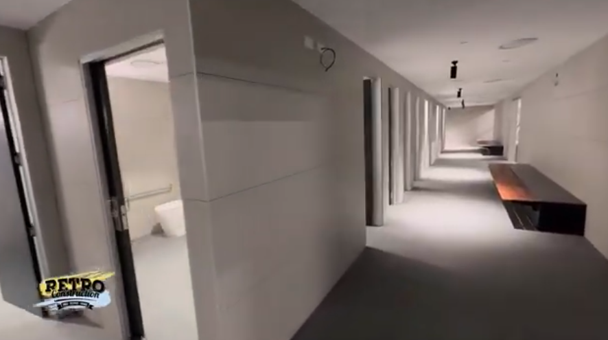 Hallway interior design. A long corridor with benches and doors, showcasing construction project.