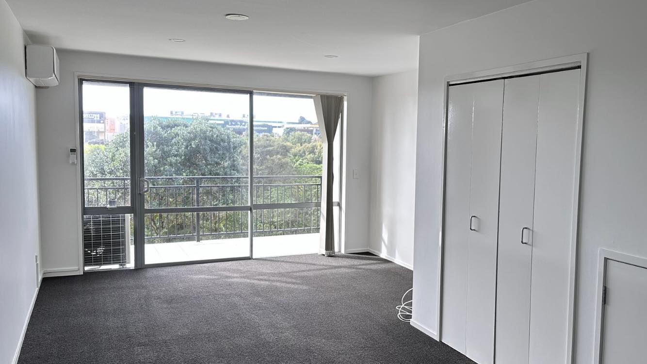 Apartment refurbishment: Modern living room with balcony, white closet, and gray carpet. Interior design.