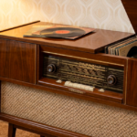 Retro radio and record player. Vintage wood cabinet with vinyl records. Classic audio equipment for radio ads.